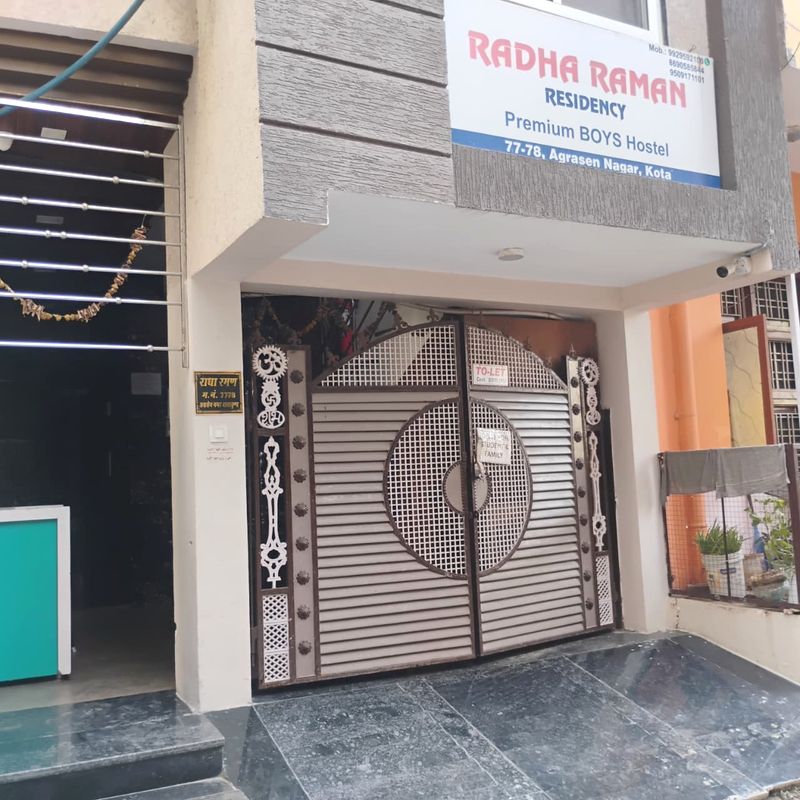 Radha Raman Residency main entrance gate showing premium student boys pg signboard