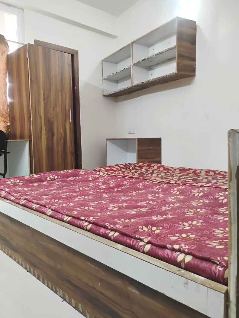 Student room interior showing beds and study desk setup at Radha Raman Residency Kota