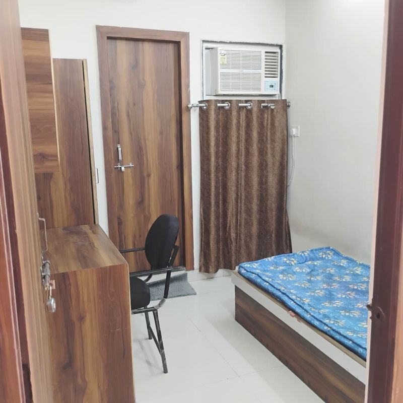 Premium student single/double AC room interior at Radha Raman Residency Kota